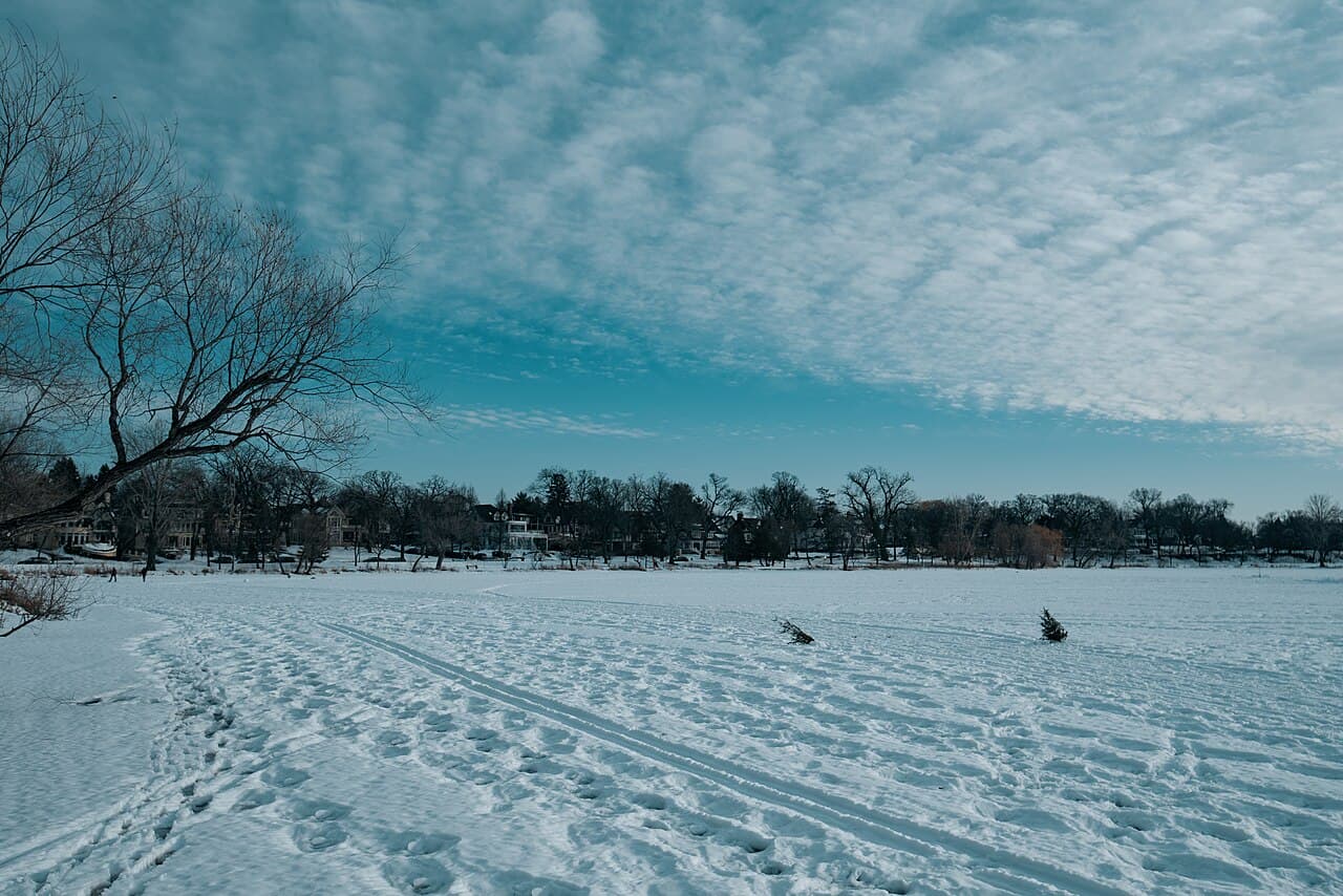 Frozen Lake of the Isles in winter, where neighbors gather on the shore