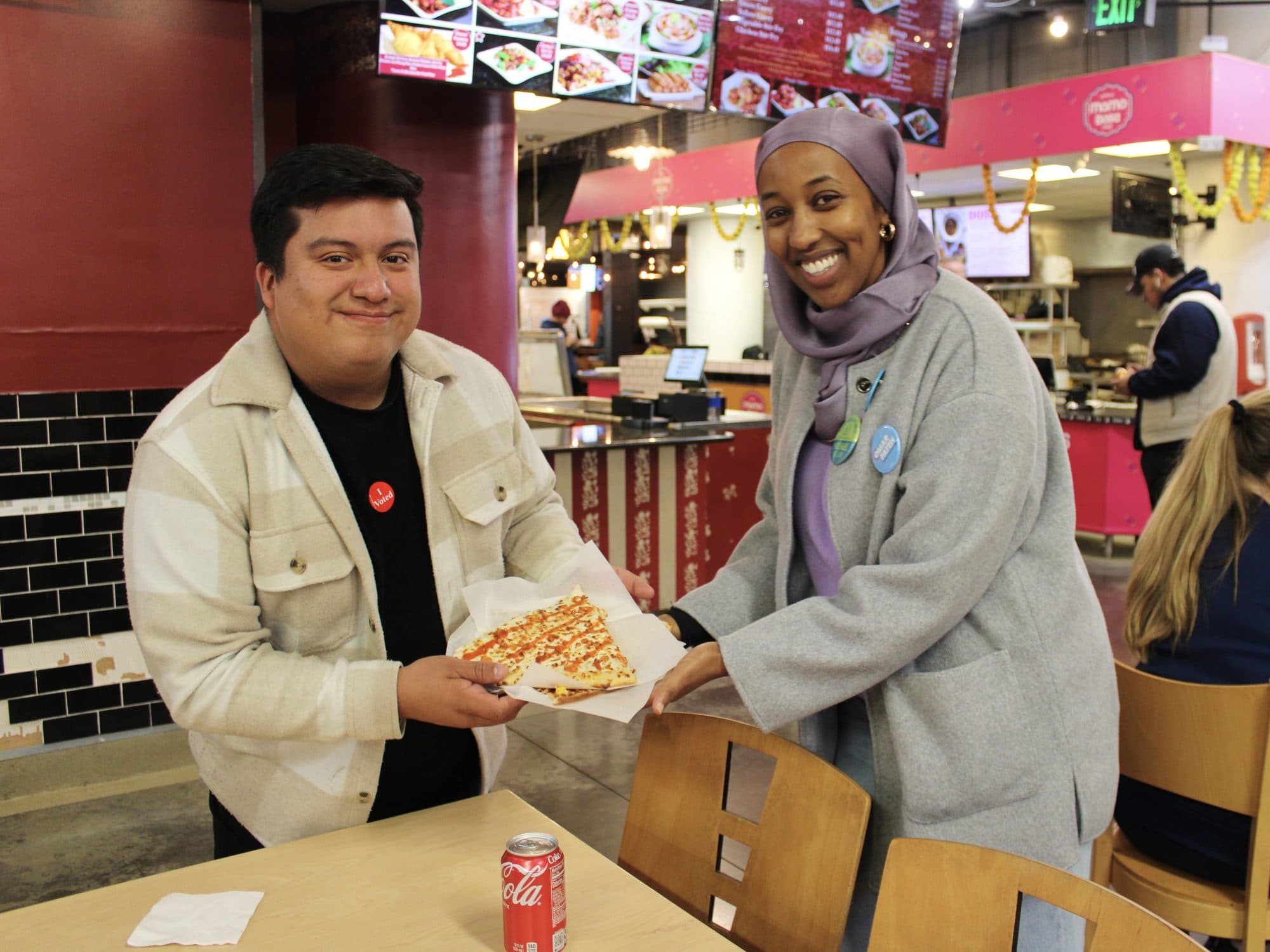 11.4.2025 - Jason Chavez and Anquam Mahamoud with Slice Pizza at Midtown Global Market on election day, Minneapolis
