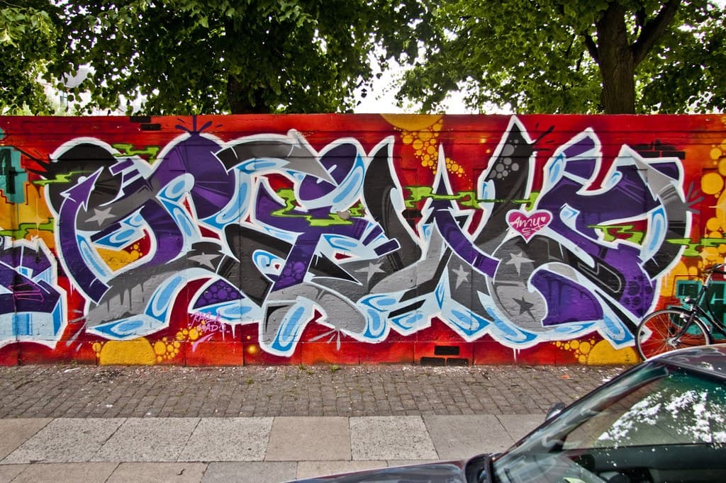 A vibrant graffiti mural painted on a street wall