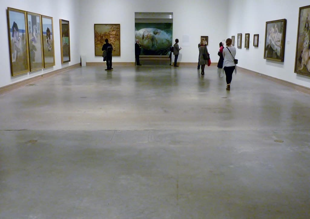 Visitors in a contemporary art museum gallery with large paintings
