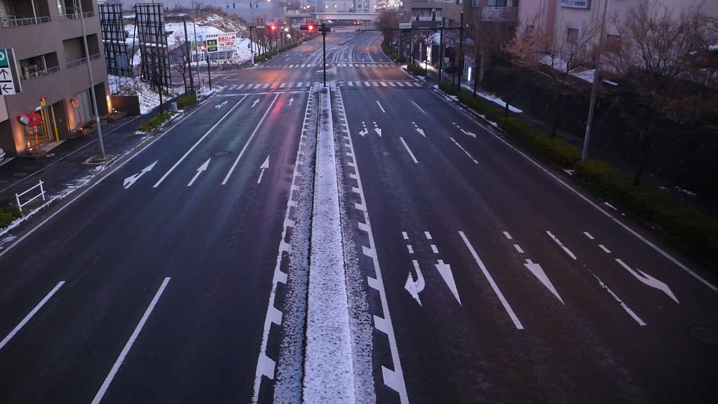 Road salt scattered on a snowy winter street
