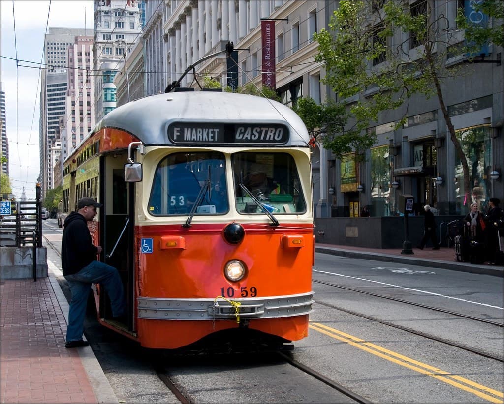 A frequent city bus arriving at a transit stop