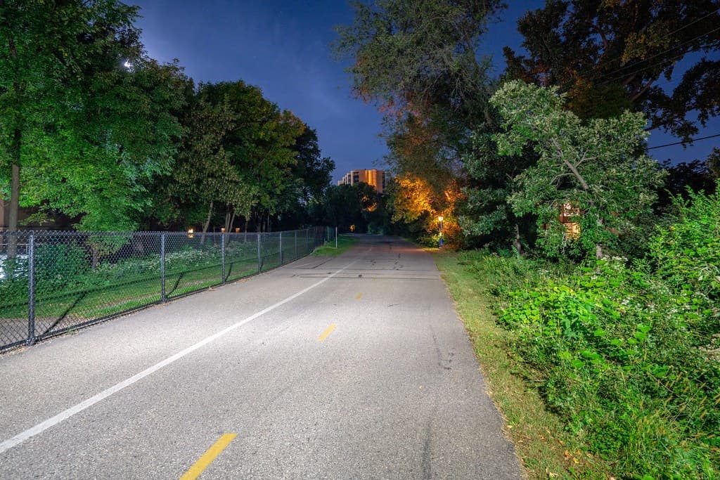 A cyclist commuting along a city bike trail